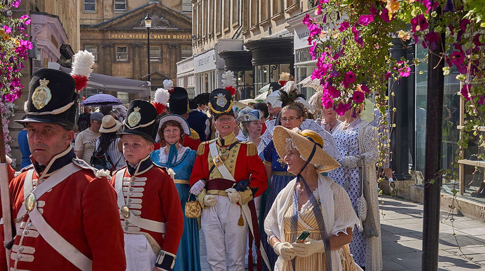 Parade of people dressed in period costume from the Georgian era as part of the annual Jane Austen festival in Bath in Somerset